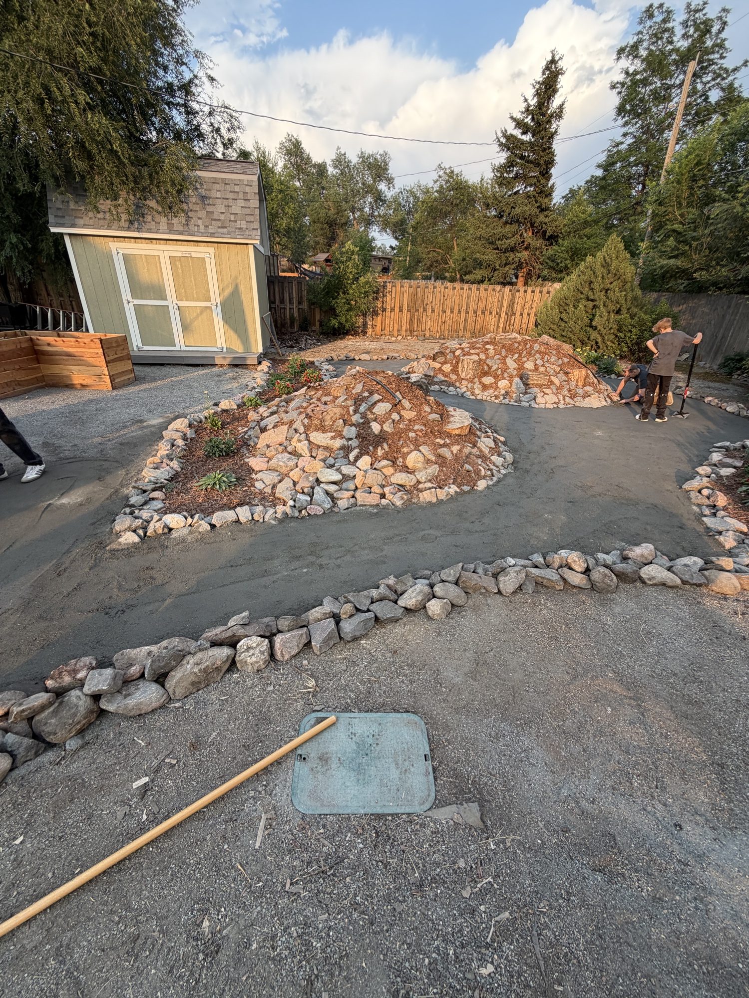 The path running the length of the yard, with the planted beds and stone edging alongside it.