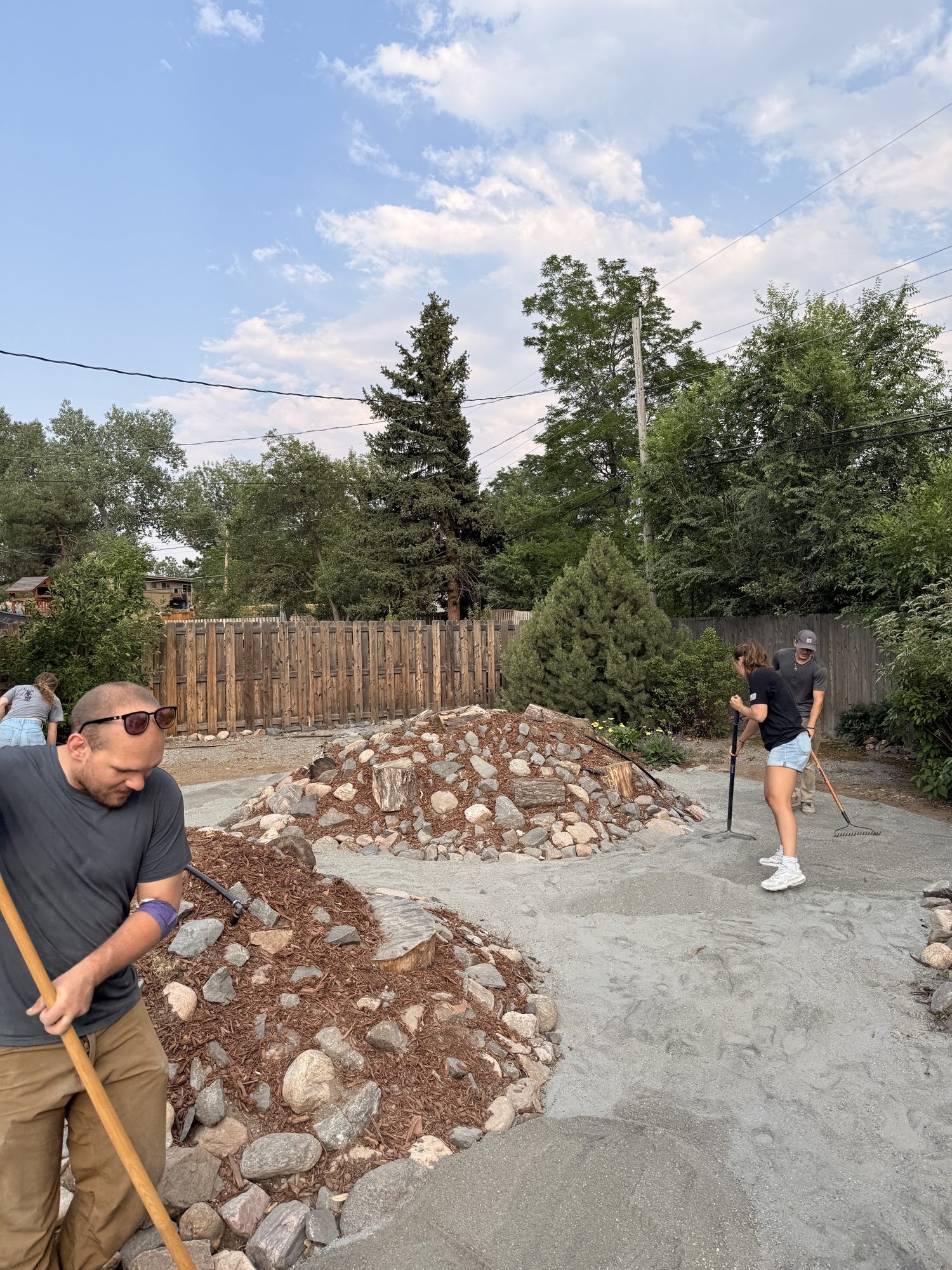 Raking the gravel out level between the planted beds.